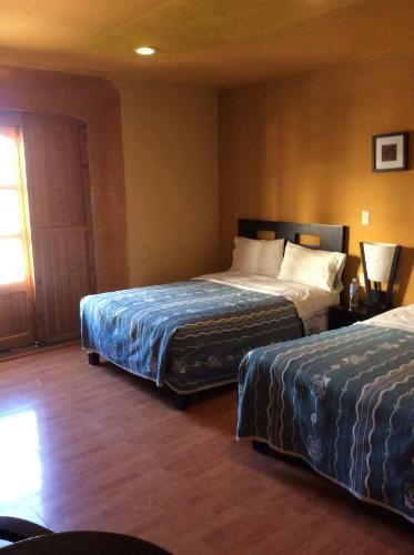 Postel nebo postele na pokoji v ubytování Hotel Plaza Mayor