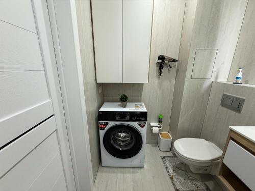 1 комнатная квартира в центре города на Победы 70 في كوستاناي: حمام صغير مع غسالة ومرحاض