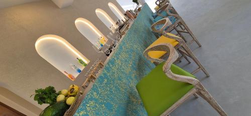 a table with a green chair and some scissors at Brizo Paradiso in Matara