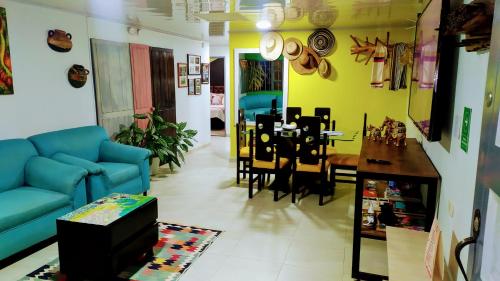 a living room with a blue couch and a dining room at Magical house in Salento Wiht prívate jacuzzi in Salento