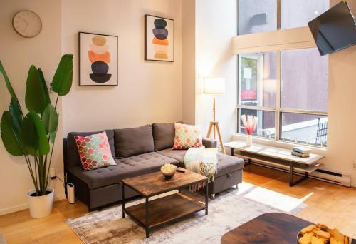 a living room with a couch and a table at The Urban Lofts in Vancouver