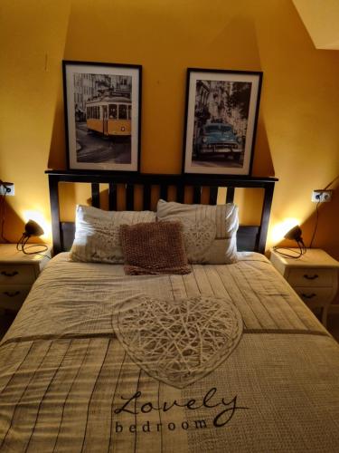 a bedroom with a large bed with three pictures on the wall at De Oude Bakkerij in Onderdendam