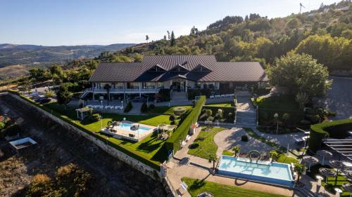 an aerial view of a house with a swimming pool at Paraiso Douro in Lamego