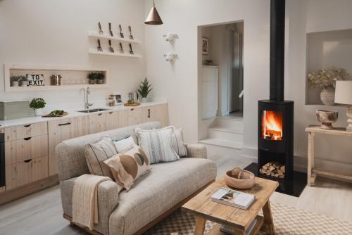 a living room with a couch and a fireplace at Kennet in Marlborough