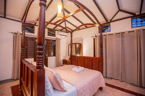 a bedroom with a canopy bed in a room at Mountvilla Exquisite 4-Bedroom Luxury Retreat with Private Pool in Galle