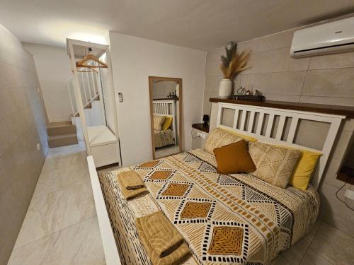 a bedroom with a large bed and a mirror at Casuccia Theatre Apartment by Doors Valletta in Valletta
