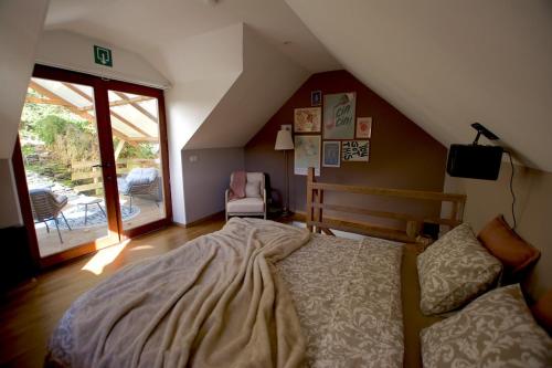a bedroom with a large bed in a attic at Charmante maison dans le centre & vue sur château in La Roche-en-Ardenne