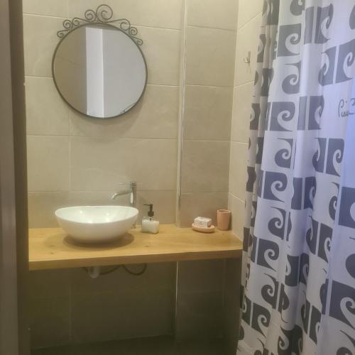 a bathroom with a sink and a mirror at loft ΑLEXIA in Pyrgos