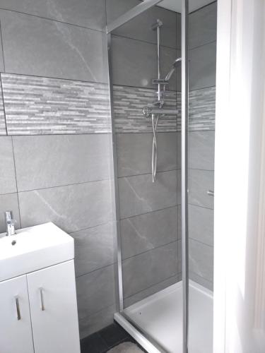 a shower with a glass door in a bathroom at Views for miles in Monmouth