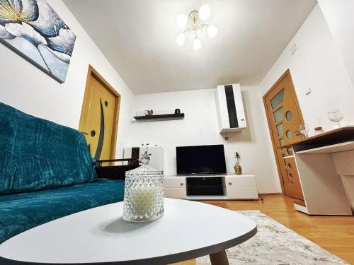 a living room with a couch and a table at BDR Residence in Craiova