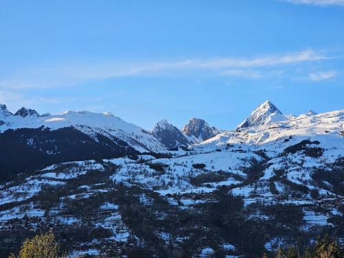 a snow covered mountain range with mountains in the background at Chalet coeur d'alpage La Plagne Les Arcs in La Plagne Tarentaise