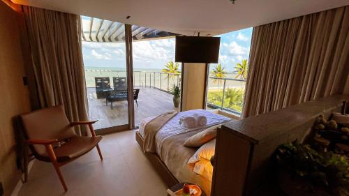 a bedroom with a bed and a view of the ocean at Setai Aquamaris by Setai Apartaments in João Pessoa
