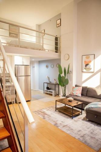 a living room with a couch and a table at The Urban Lofts in Vancouver