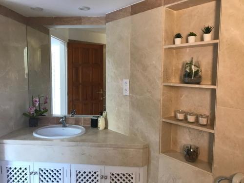 a bathroom with a sink and a mirror at La Manga Club, Las Palmeras 12 in Cartagena