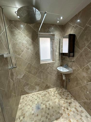 a bathroom with a shower and a sink at Cosy Family Home in Lovely Stony Stratford in Stony Stratford