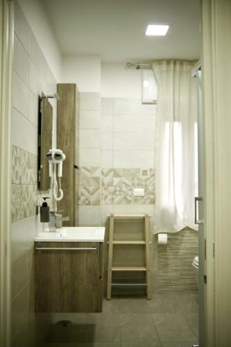 a bathroom with a ladder next to a sink at Parthenope Luxury Apartment in Naples