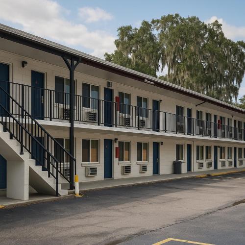 a building with blue doors and balconies on it at Travelodge by Wyndham Gainesville in Gainesville