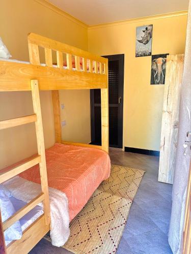 a bedroom with two bunk beds in a room at J&T Homestay in Karatu