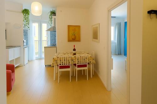 a kitchen and dining room with a table and chairs at Domus Appio Latino - Parco Appia Antica in Rome