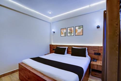 een slaapkamer met een groot bed met witte lakens bij Collection O Baga Beach Goa Formerly Traveller Guest House in Baga