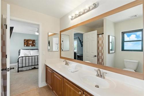 a bathroom with a sink and a large mirror at Splash Canyon - Splash Pad & Tons of Games - Gym in Chandler