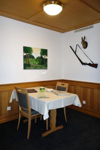 a table in a room with a white table cloth on it at Gasthof Löwen in Melchnau