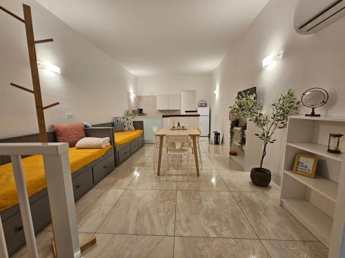 a small living room with a couch and a table at Casuccia Theatre Apartment by Doors Valletta in Valletta