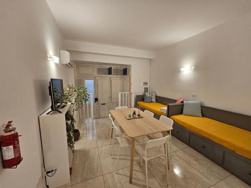 a small apartment with a table and a couch at Casuccia Theatre Apartment by Doors Valletta in Valletta