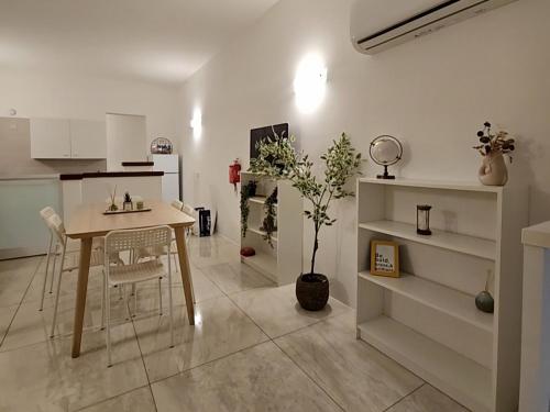 a kitchen with a table and chairs in a room at Casuccia Theatre Apartment by Doors Valletta in Valletta