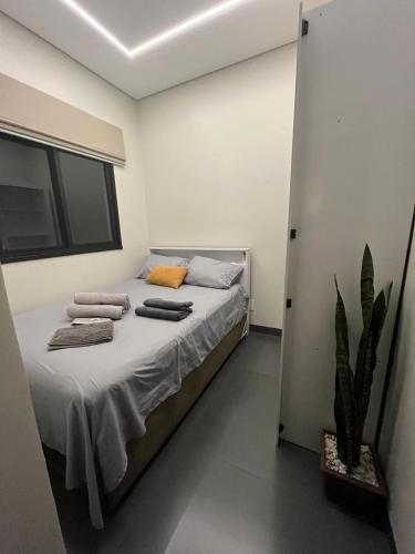 a bedroom with a bed with two towels on it at Edícula para descansar e passar ótimos momentos in Foz do Iguaçu