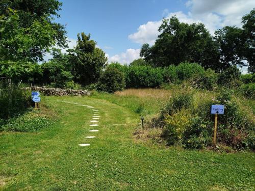 a dirt road in a field with signs on it at Tinyhouse, winter cocoon, quiet and nature in Languidic