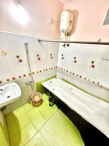 a bathroom with a bath tub and a sink at KPS homestay in Pondicherry