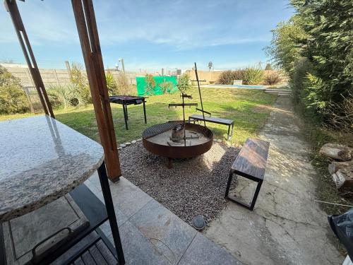 a backyard with a fire pit and a table and benches at Quinta Canning MyP in Canning