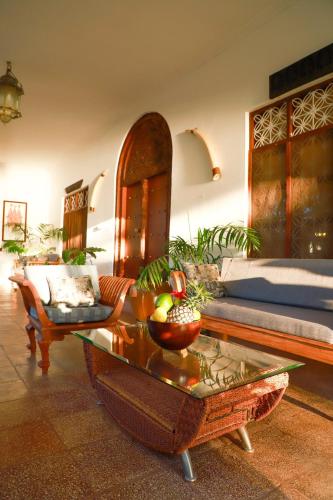 a living room with a bed and a coffee table at Emerald Sunset Villa in Zanzibar City