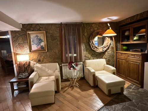 a living room with two chairs and a table at Villa TIANA Bansko 7-Bedroom Luxury Chalet in Bansko