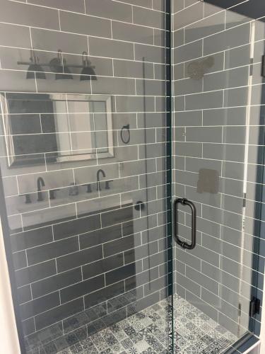 a bathroom with a shower with a glass door at Sierra Del Feugo apt # B in Ivins