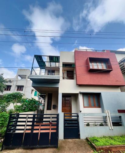 a white building with a red roof at Villa Sereno Belgaum in Belgaum