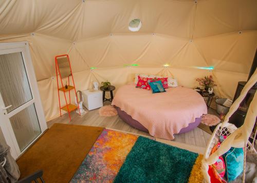 a bedroom with a bed in a tent at Wonderland in Henfield