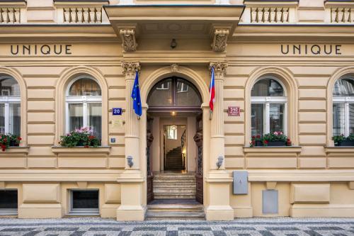 a building with two flags in front of it at Hotel Unique in Prague