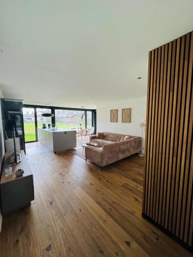 a large living room with a couch and a table at Haus Am Anger Dornbirn in Dornbirn