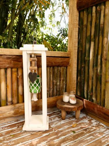a white lantern sitting on a porch with a table at Lauro Muller, Rancho Queimado in Louro Müller