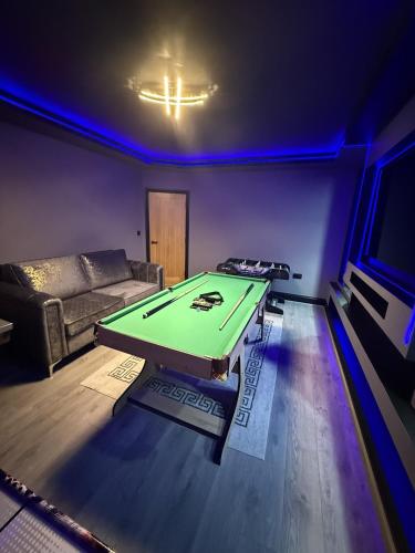 a living room with a ping pong table in it at SK Stays Modern Luxury Home With Jacuzzi Bath & Cinema Room in Shipley