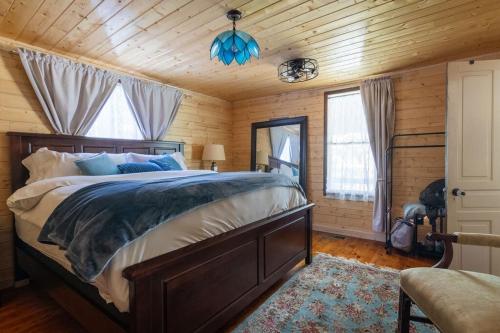 a bedroom with a large bed in a wooden room at Captain's Cabin in Burnsville