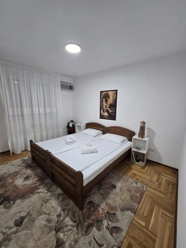 a bedroom with a large bed in a room at Stan na dan Centar Čačak in Čačak
