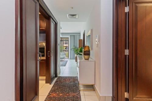 a hallway with a door and a room with a rug at Downtown Zaafaran 2, in Dubai
