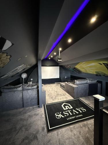 a room with a gym with a sign on the wall at SK Stays Modern Luxury Home With Jacuzzi Bath & Cinema Room in Shipley