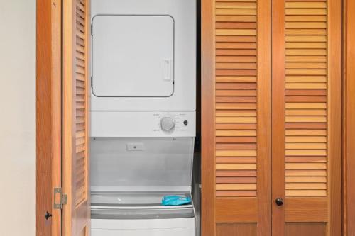 a refrigerator with a washer and dryer in a room at WorldMark Chelan - Lake House in Chelan