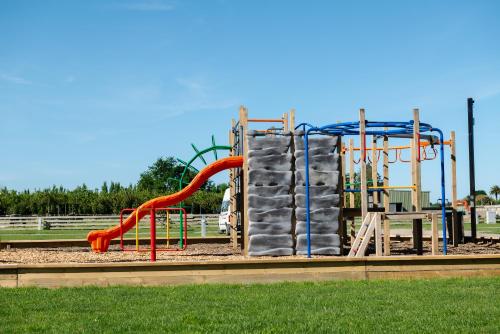 a playground with a slide in a park at Havelock North Holiday Park in Havelock North