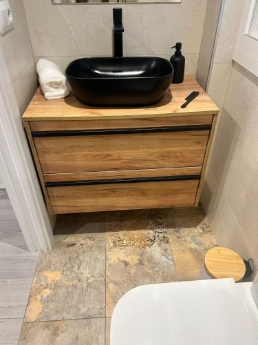 a bathroom with a black sink on a counter at Urban Suites Aluche in Madrid