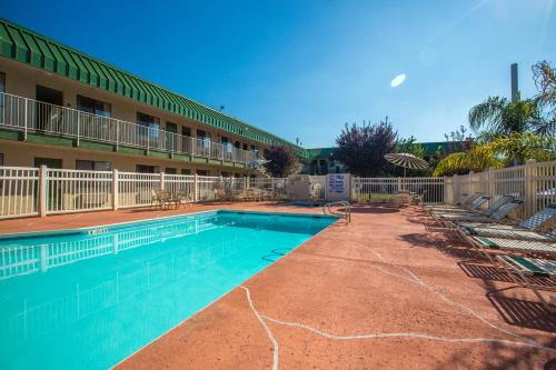 a swimming pool in front of a hotel at University Inn Fresno in Fresno